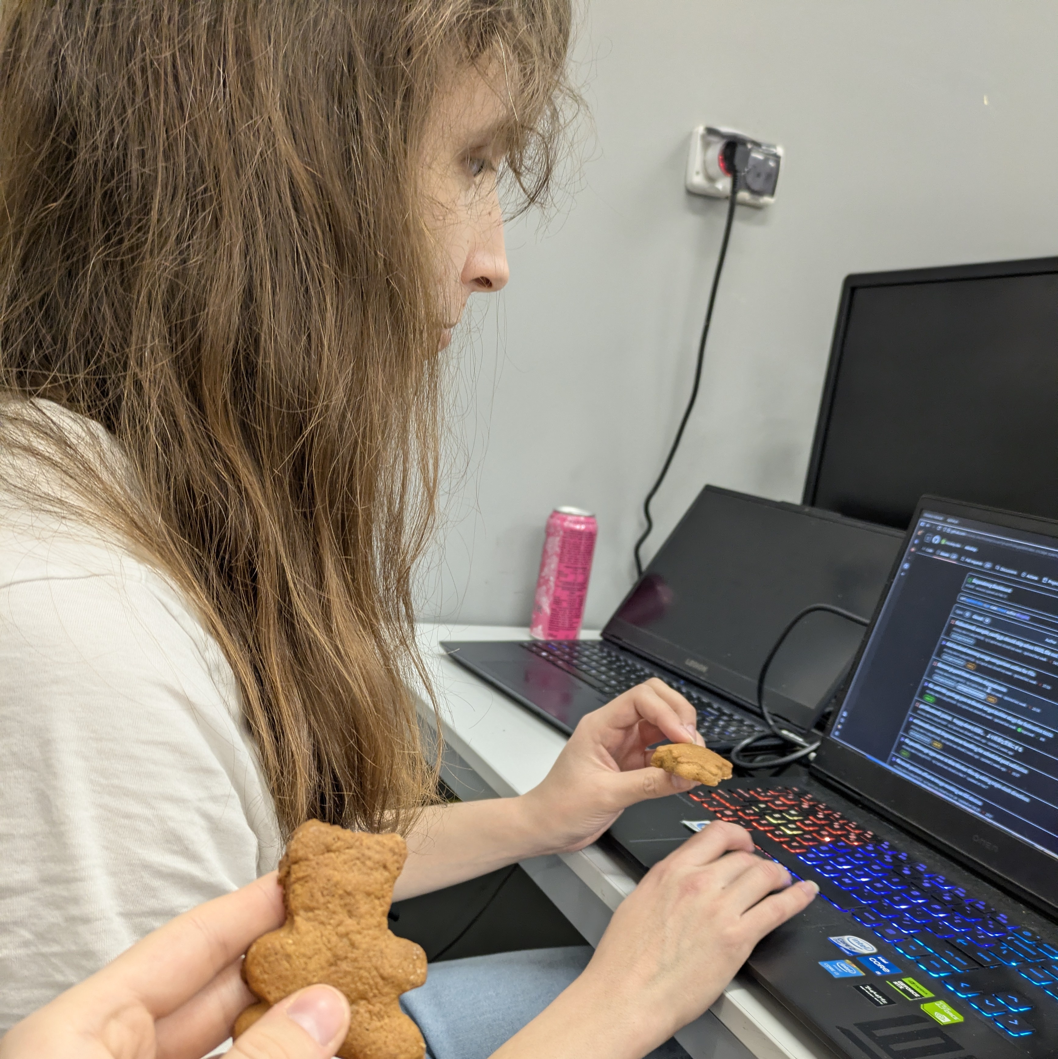 I’m on a laptop with GitHub pull requests page searching for PRs authored by copilot. I’m holding a Christmas cookie in my hand and there’s another hand holding one.